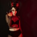 mysterious woman in dark costume with horns