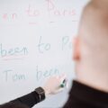 a person writing on a whiteboard