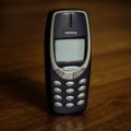 retro cellphone with buttons placed on table
