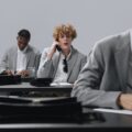 man in gray suit jacket talking to man in gray suit