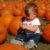 A Little Girl and Some Pumpkins