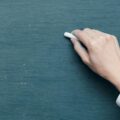 person holding white chalk