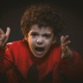 toddler with red adidas sweat shirt