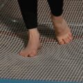 a person walking on a trampoline