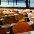 rows of tables and chairs in the classroom