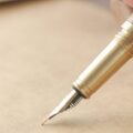 a person holding a fountain pen