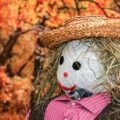 autumn scarecrow in vibrant fall forest